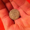 I'm not sure but I think this is a jefferson nickel stamped of standing liberty on a silver plachet.      Any ideas?