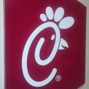 Large Chick-fil-A sign. . . deck of cards on top for reference