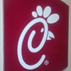 Large Chick-fil-A sign. . . deck of cards on top for reference