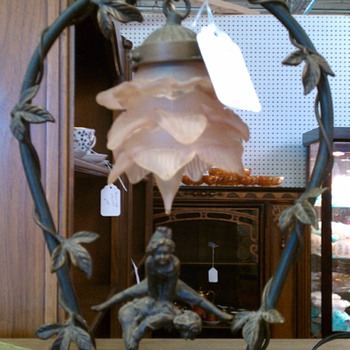 Lamp  with two children or elves playing and glass pink lampshade.