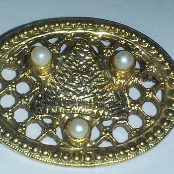 this pin/brooch has a secret/secret code in the mysterious symbolic triangle