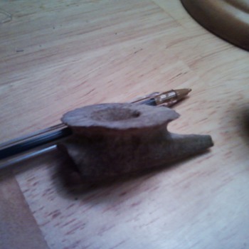 very old pipe and grinding stone