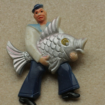 Fisherman and sunning lady brooches