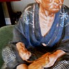Ceramic Oriental man making shoes?