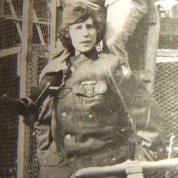Woman in 3rd Army tunic at pigeon cages!