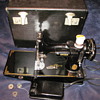 Singer sewing machine in a box with extras.