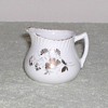 Porcelain creamer with gold design