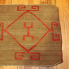 Small textile rug saddle blanket with red design