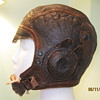 Aviator cap, metal toy gun, old eyeglasses, postcards