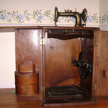 New Home Sewing Machine in Cabinet, circa late 1800s