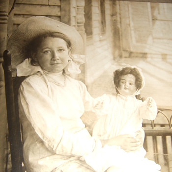 Cabinet card of smiling girl with a doll - Photographs