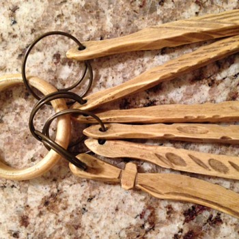 I think these are old measuring spoons of some sort.  They look to be hand carved out of bone I think?