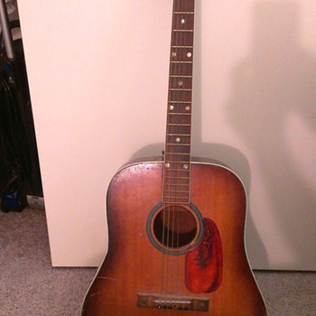 Can anyone identify this jumbo guitar?  