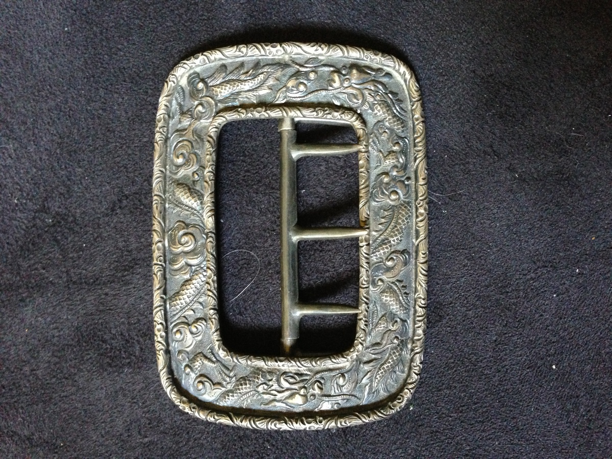 Favorite belt buckle. With makers mark. The mark looks like a feather