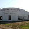 Old deserted Car Dealership . I love the shape of it .