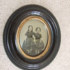 Thermoplastic wall frame with ambrotype of two girls