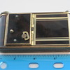 Compact featuring lipstick, music box, powder/mirror, cigarette & card holder - all in one