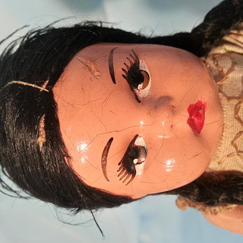 very old paper mache or composition doll mexico ?