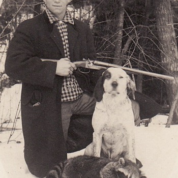 Photograph of Hunter with Shotgun, his dog and dead racoon