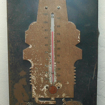 How old is the metal AC spark plug thermometer sign.