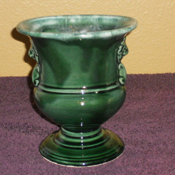 Hull pedestal vase drip brown with lions heads.