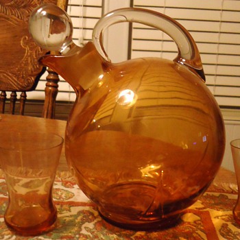 Orange pitcher and 3 glasses, 7 inches tall, What kind of glass? when made?Mystery solved! Cambridge glass 1930's art deco