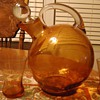 Orange pitcher and 3 glasses, 7 inches tall, What kind of glass? when made?Mystery solved! Cambridge glass 1930's art deco