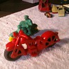 Old toy motorcycles.  The red is a hard plastic Harley or Indian and the other is most likely an Auburn Rubber toy