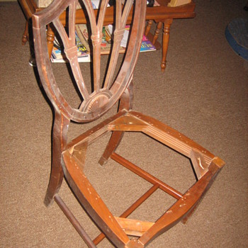 A set of federal shield back chairs.
