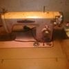 it says Voguestitches pink sewing machine in wooden cabinet