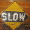 old slow sign saved from being used as a fire pit lid