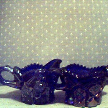Dark blue, believe carnival glass, diamond cut on top, etc. creamer & sugar bowl. Can't find name to save my life. Someone HELP - Glassware