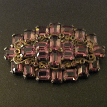 Faceted purple stones set in base metal