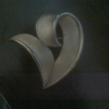 Trifari brooch it is gold tone brushed not a very good picture but would love any info on this