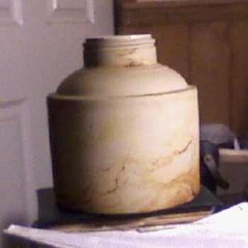 I know that it is stoneware... no evidence of a lable or markings of any kind as well as a non threded neck....