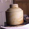 I know that it is stoneware... no evidence of a lable or markings of any kind as well as a non threded neck....
