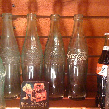 Small collection of old Coke Bottles