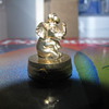 Gold timepiece elephant pendant