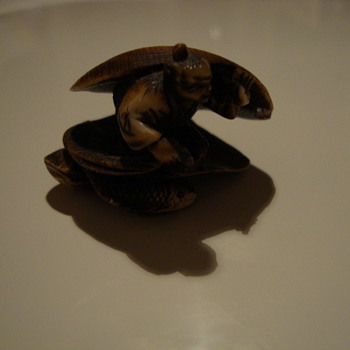 man in open shell netsuke