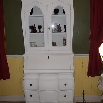 Antique Cabinet covered in cloth.