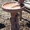 Two squirrels on a faux bois tile birdbath