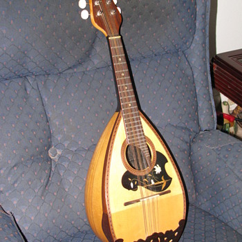  A suzuki Mandolin made by Kiso Suzuki Violin co. L.T.D. Japan.  I believe it was made in the early 1900's.  