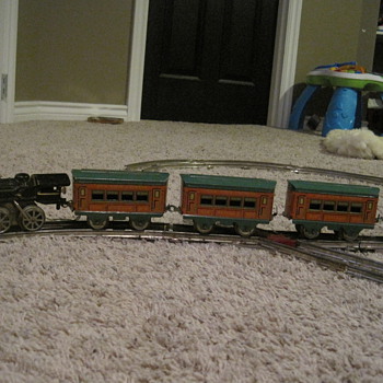 Cast iron engine with train cars and track