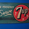 We Proudly Serve 7Up sign