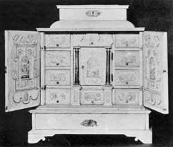 ILLUSTRATION VII: A 17th-Century Italian Cabinet: Made of polished bone and decorated with miniature landscapes the door in the center, flanked by column pilasters, is the same design used in English and American desk interiors of the 18th and early 19th Centuries. When this central door is opened it discloses a compartment with a false back, behind which is a double tier of small drawers. ILLUSTRATION VII: A 17th-Century Italian Cabinet: Made of polished bone and decorated with miniature landscapes the door in the center, flanked by column pilasters, is the same design used in English and American desk interiors of the 18th and early 19th Centuries. When this central door is opened it discloses a compartment with a false back, behind which is a double tier of small drawers.
