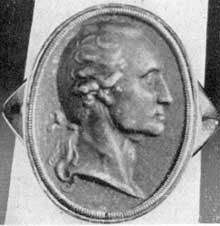 ILLUSTRATION II: A Berlin Casting Ring: Originally owned by General Daniel Keim of Reading, Pa., it was erroneously considered as a pallbearer's token. Size 14/16 by 10/16 inches, the same as the Lear brooch and pin, showing another use of the same oval portrait bust; miniature made of iron. ILLUSTRATION II: A Berlin Casting Ring: Originally owned by General Daniel Keim of Reading, Pa., it was erroneously considered as a pallbearer's token. Size 14/16 by 10/16 inches, the same as the Lear brooch and pin, showing another use of the same oval portrait bust; miniature made of iron.