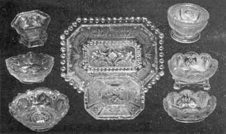 All Lacy Sandwich Pieces: In the center is an eight-sided deep dish, 7 inches long. Beneath it is a salt dish of the same shape. At the upper left is an octagonal salt dish with leaf design; and at the upper right, a circular one with round panels depicting the ship Cadmus. All Lacy Sandwich Pieces: In the center is an eight-sided deep dish, 7 inches long. Beneath it is a salt dish of the same shape. At the upper left is an octagonal salt dish with leaf design; and at the upper right, a circular one with round panels depicting the ship Cadmus.