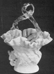 A Mold-Blown Basket: The exterior is of opalescent overlay glass; the interior a delicate rose color; handle of clear glass. Height, 9 inches; width, 5 inches. A Mold-Blown Basket: The exterior is of opalescent overlay glass; the interior a delicate rose color; handle of clear glass. Height, 9 inches; width, 5 inches.