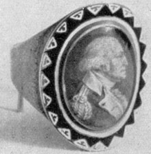 ILLUSTRATION VI: A St. Memin Ring: This artist engraved two miniature portraits of Washington. This is the one in uniform. The other was a profile, laureated. Both were colored to simulate painted miniatures. Ring, probably the work of John Baptiste Dumoutet, Philadelphia goldsmith.Size 10/16 by 8/16 inches. ILLUSTRATION VI: A St. Memin Ring: This artist engraved two miniature portraits of Washington. This is the one in uniform. The other was a profile, laureated. Both were colored to simulate painted miniatures. Ring, probably the work of John Baptiste Dumoutet, Philadelphia goldsmith.Size 10/16 by 8/16 inches.