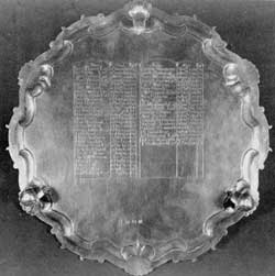 The Atkinson Silver Waiter: Shown here is the underside of this piece of English hallmarked silver with the engraving by William Cario. Recorded on it are the names, dates of death and ages of forty-eight Portsmouth residents from 1740 to 1771 at whose funerals Theodore Atkinson, as a pallbearer, received mourning rings. Evidently he sold these, bought this waiter and had the names of the people whose rings he had received engraved on the back. This engraving also includes the lettering "W.Cario — Sculp." The Atkinson Silver Waiter: Shown here is the underside of this piece of English hallmarked silver with the engraving by William Cario. Recorded on it are the names, dates of death and ages of forty-eight Portsmouth residents from 1740 to 1771 at whose funerals Theodore Atkinson, as a pallbearer, received mourning rings. Evidently he sold these, bought this waiter and had the names of the people whose rings he had received engraved on the back. This engraving also includes the lettering "W.Cario — Sculp."